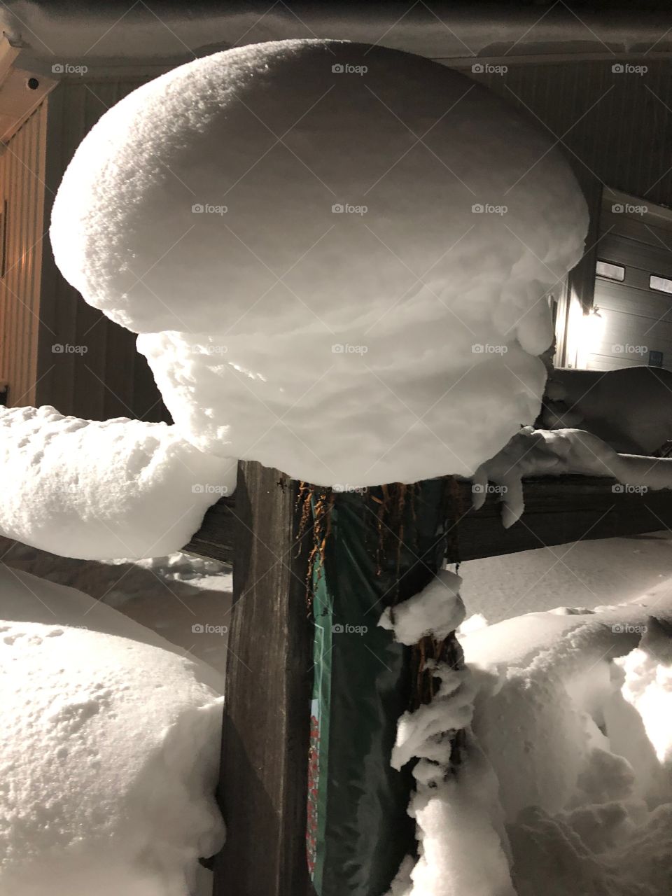 1 1/2 foot snowdrift on fencepost 