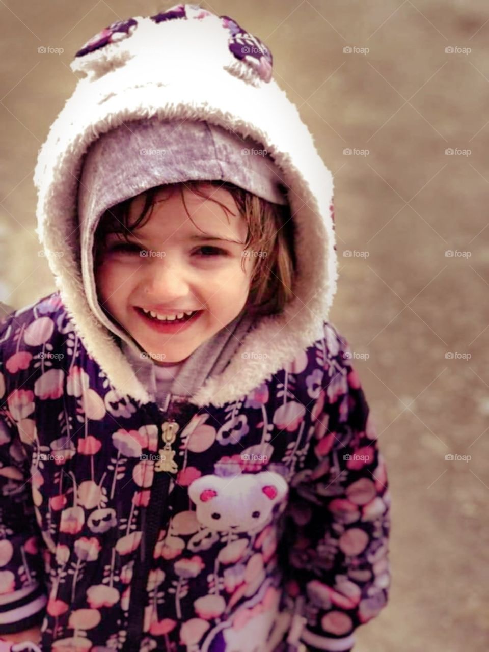 a little girl smiling under the rain