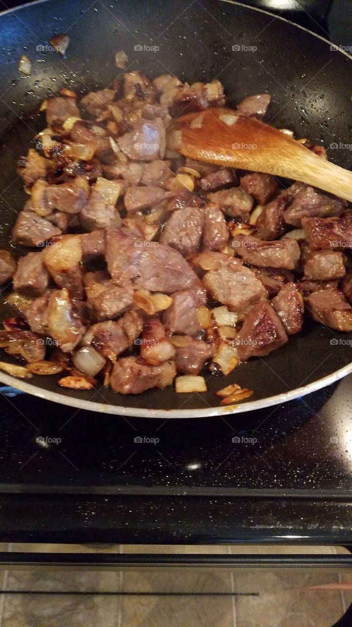 Meat cooking in a frying pan
