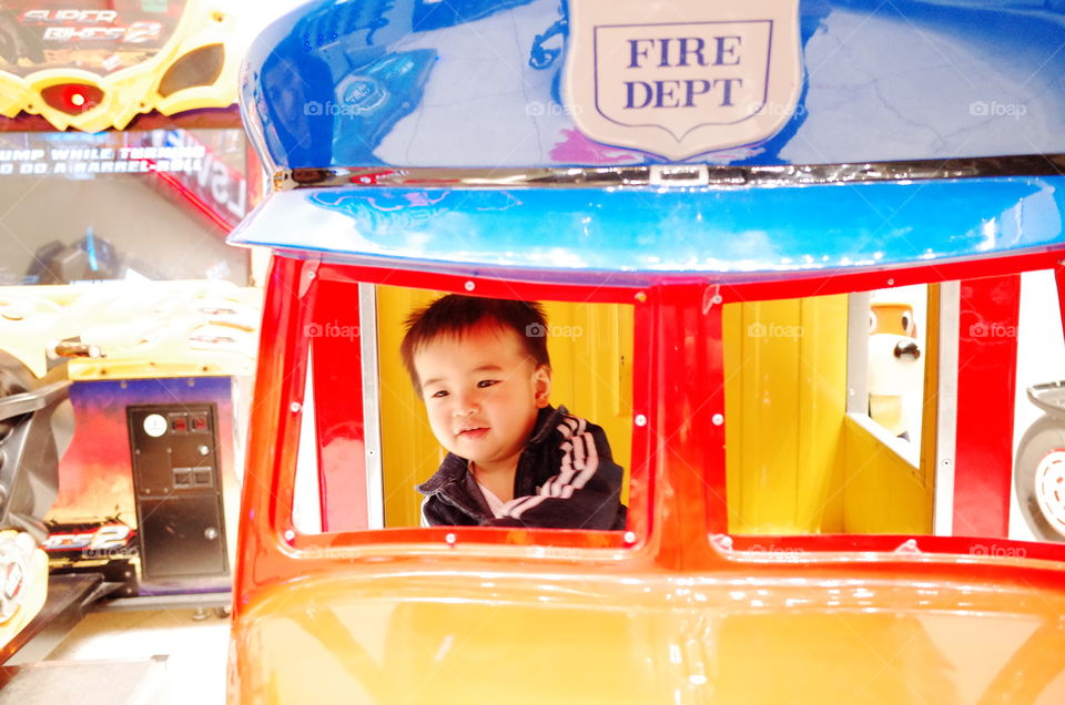 toddler playing and driving arcades having fun