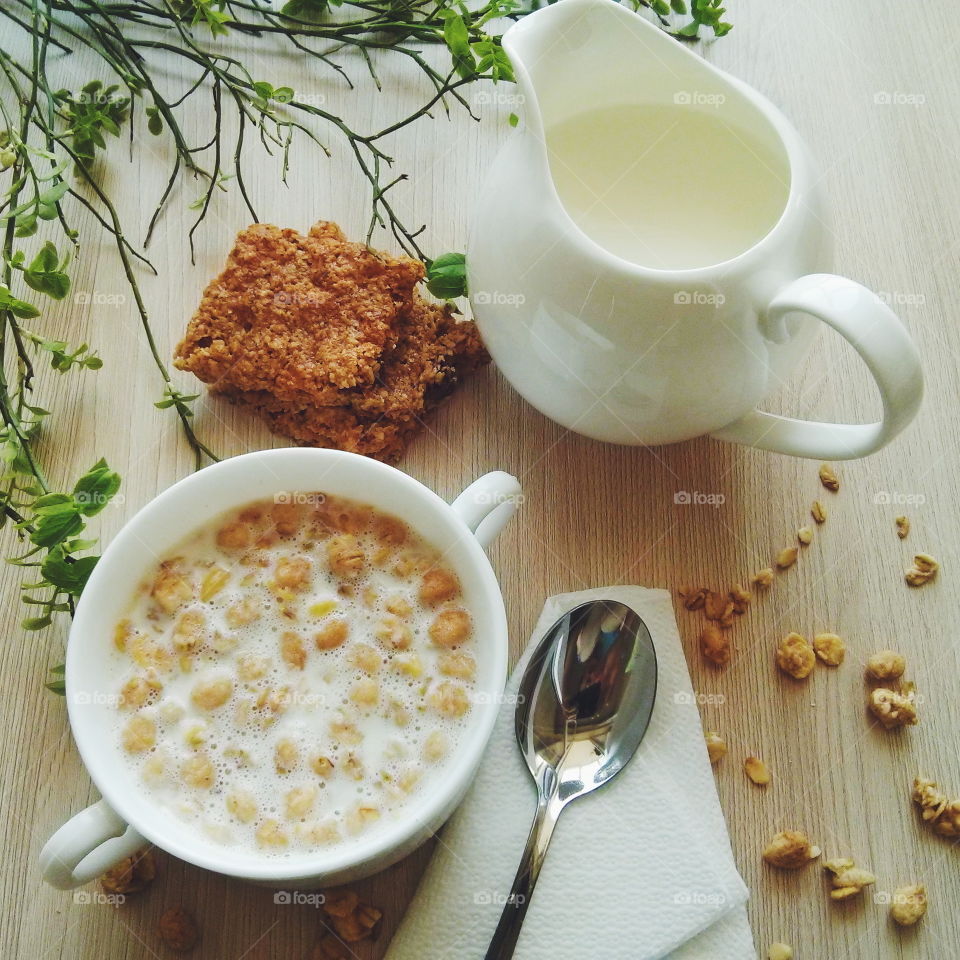 Oatmeal. Oatmeal with milk on wooden background