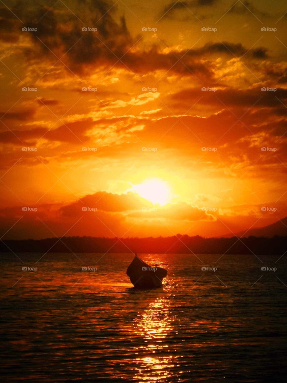 Boat at Sunset, at Ilha do Cardoso (Cardoso Island), Brasil. Beautiful Orange Sunset. Fisherman boat.