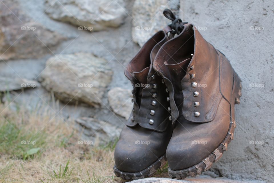 Close-up of hiking boot on rock