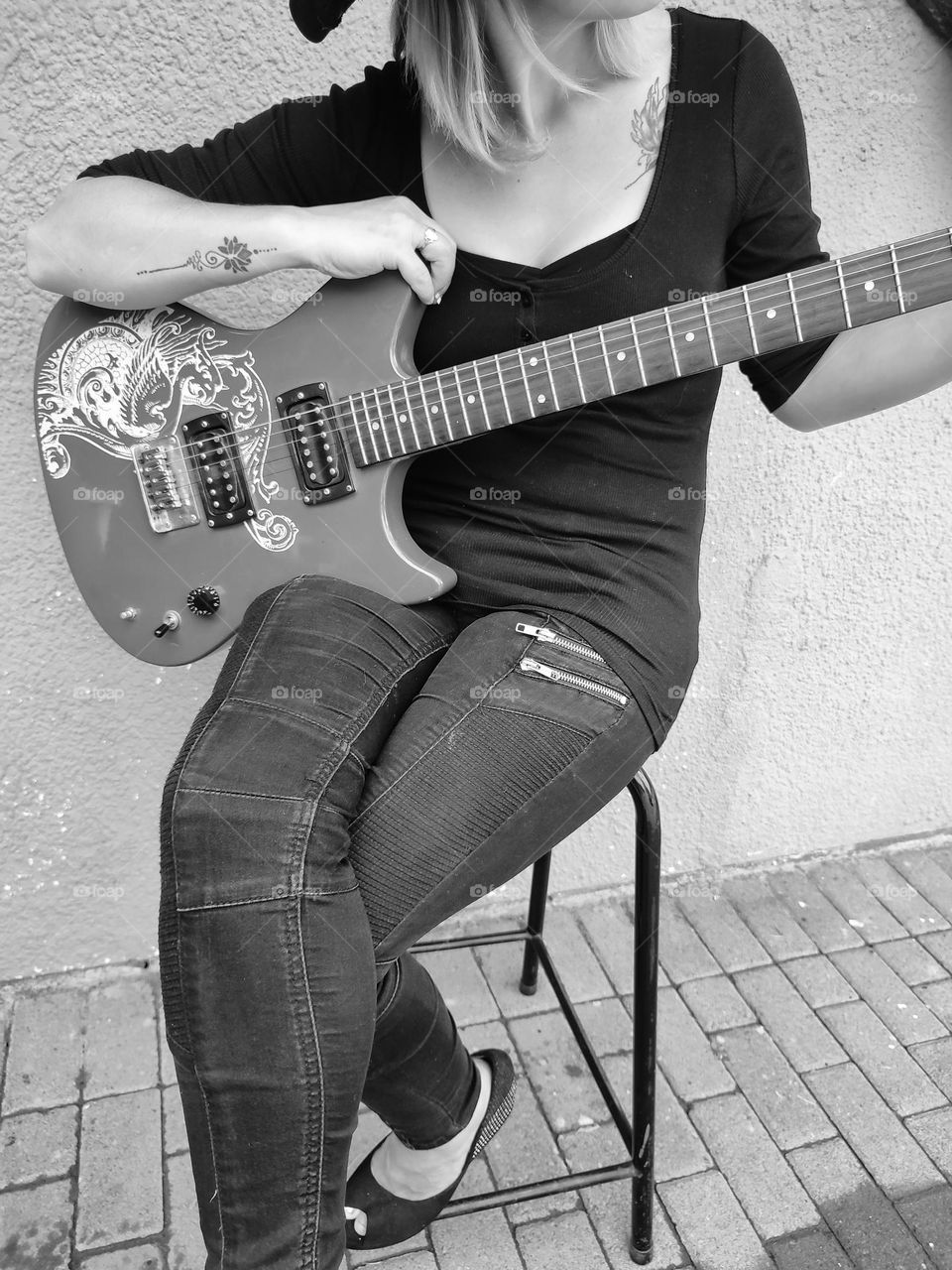 Female sitting with Electric Guitar