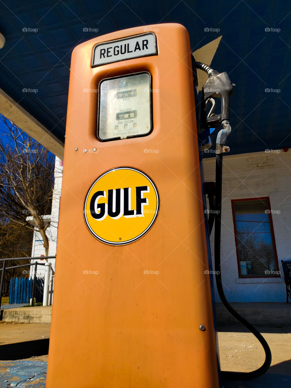 A relic survivor sits at a abandoned gas station