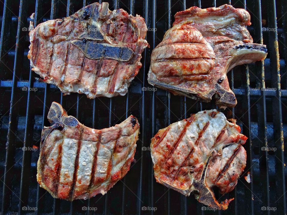 Pork chops cooking on a barbecue grill
