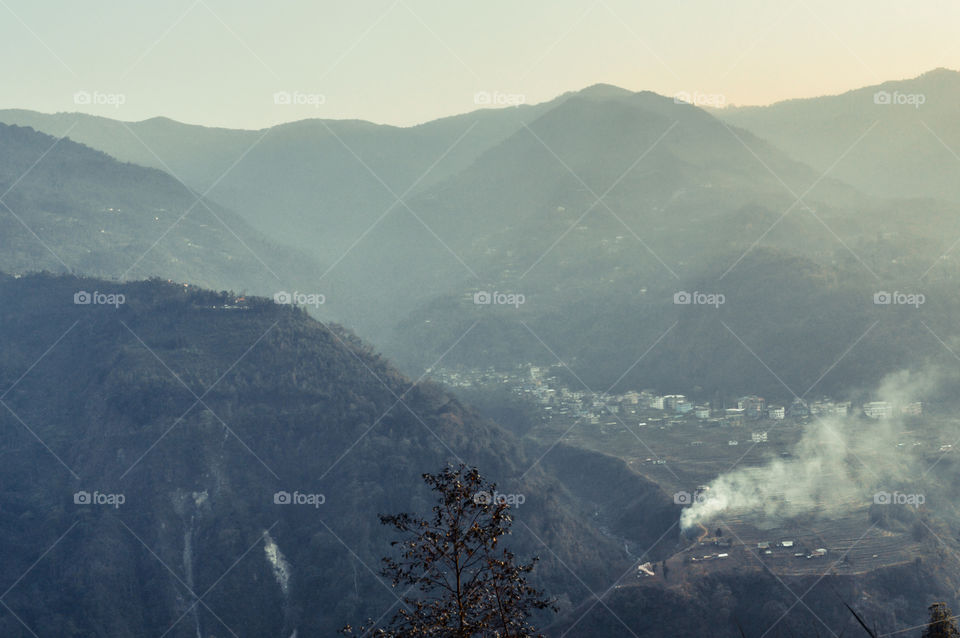 In the jungle to top mountains. Aerial, panoramic view of a forest in the mountains on a foggy day with copy space. Manali, Himachal Pradesh, India