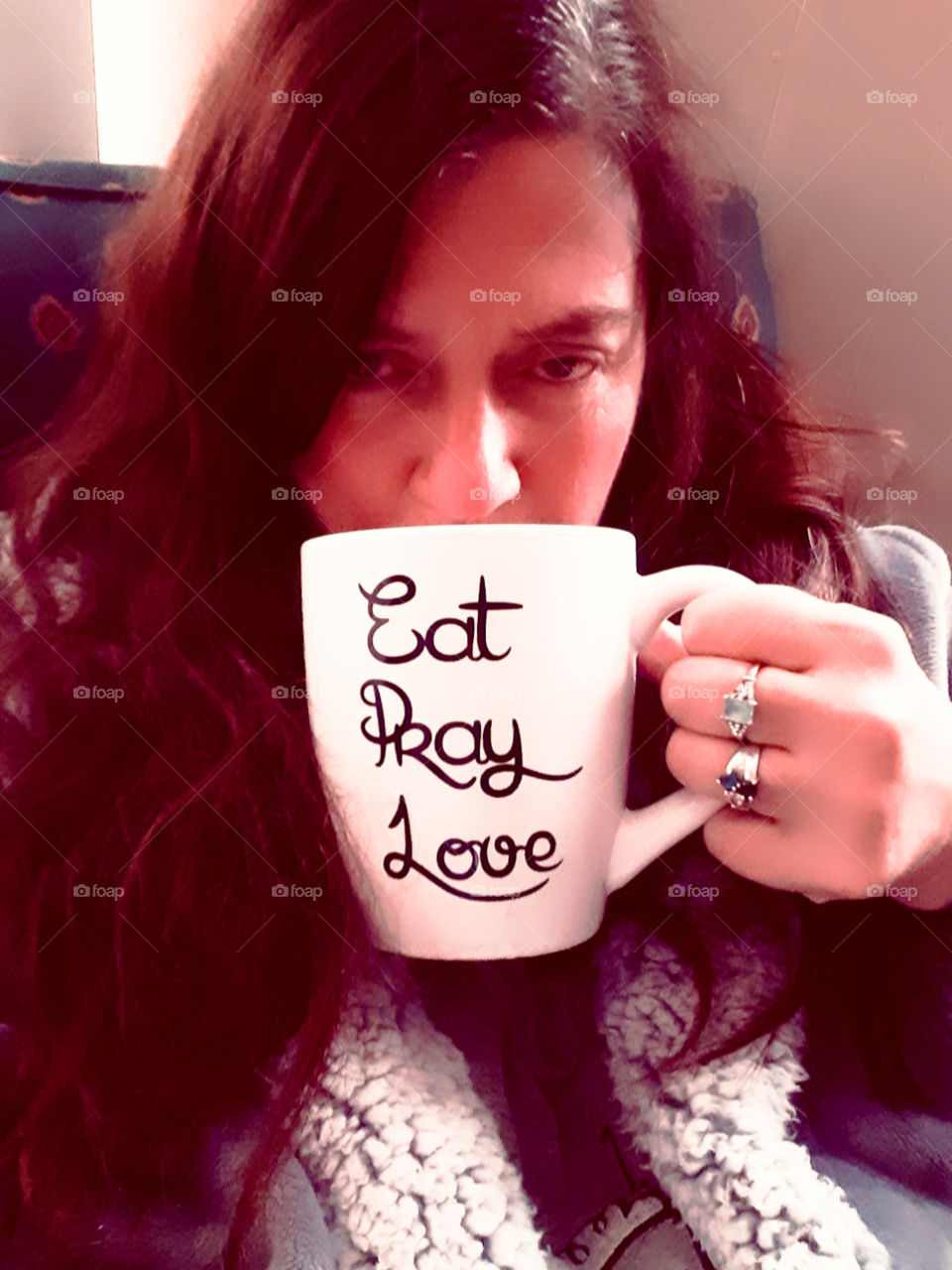woman of 50 wearing rings and a robe drinking my first cup of coffee in the morning