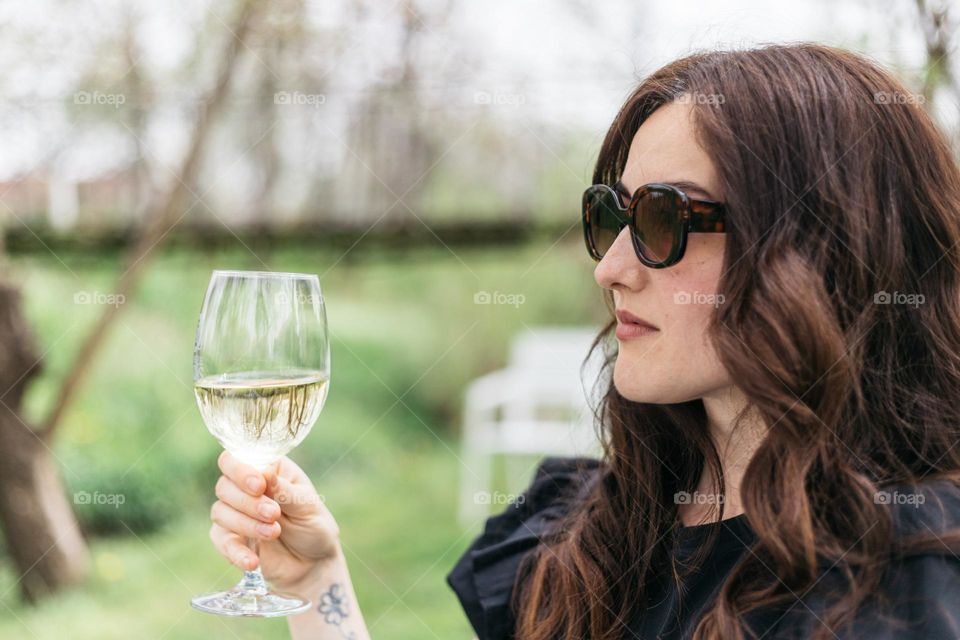 Woman drinking white wine.