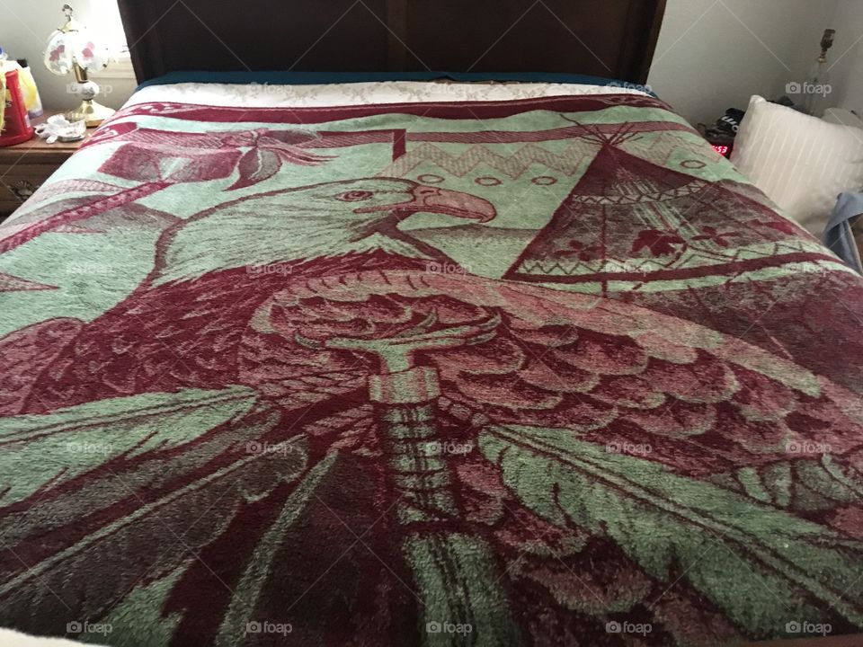 My thick heavy warm wool blanket with an eagle, teepee and feathers. It’s red in color.