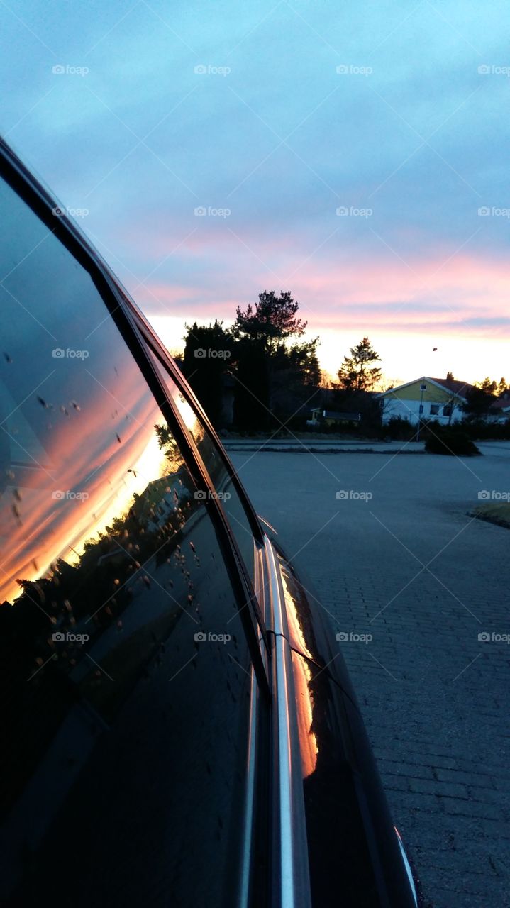 Sunset reflection on car Window.