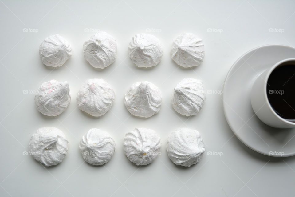 sugar meringues and coffee cup top view white background