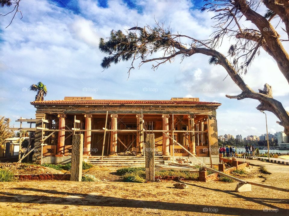 Landscape The ruins of one of the old palaces are seen during the restoration process before the sun sets, and the sun and the sun behind the building look like a very beautiful landscape