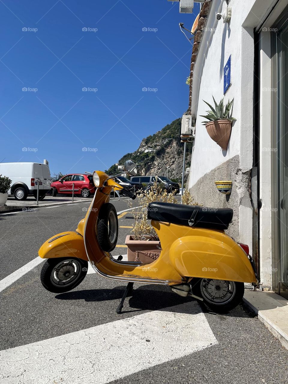 Yellow retro scooter at the street 