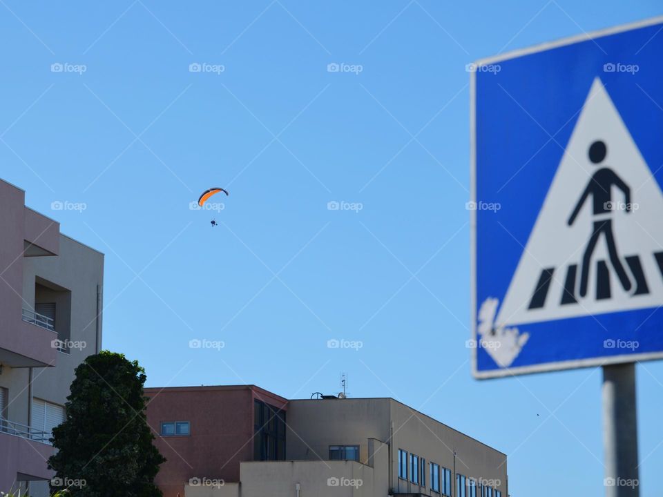 Paragliding in the cloudless blue sky 