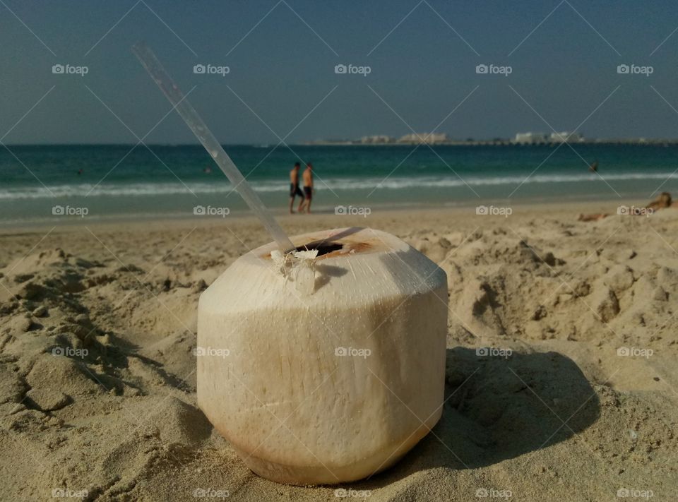 drinking coconut on the beach in Dubai during Christmas time