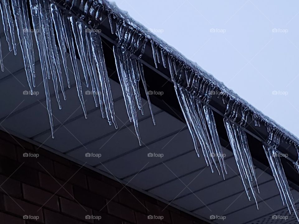 icicles on roof in the winter