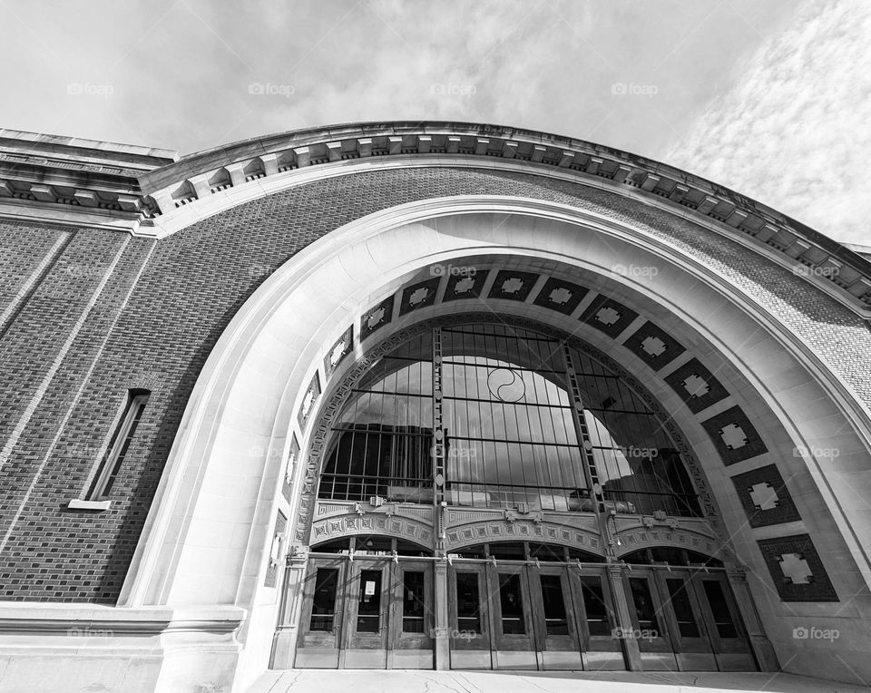 brick wall curve roof and curve archway entrance with windows on top architecture