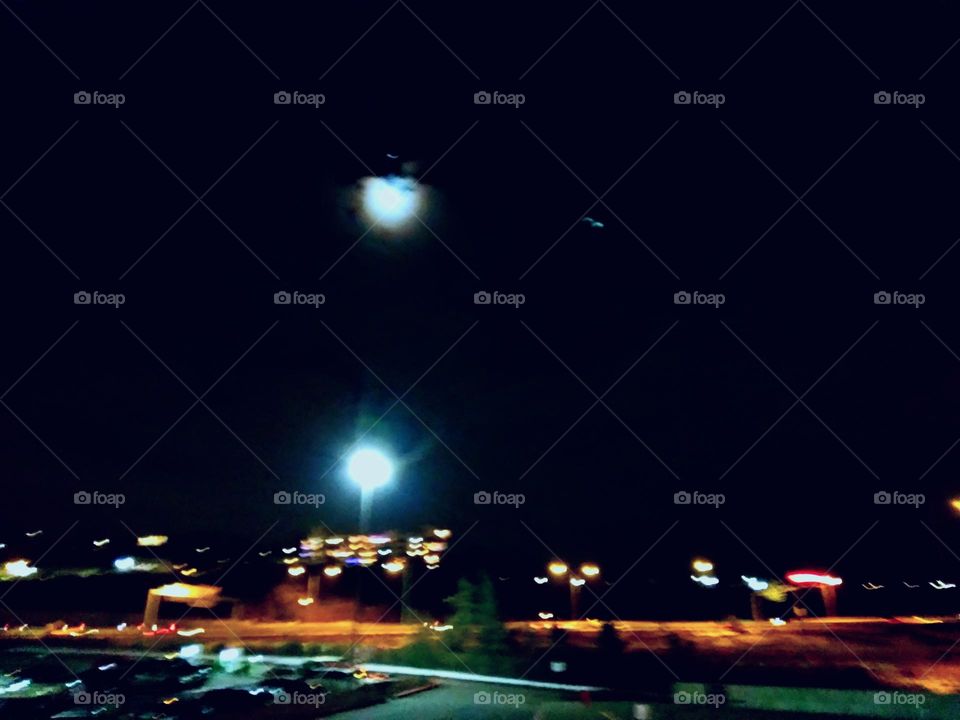 Nighttime with the airport and city lights in the background at the car museum. Clear evening