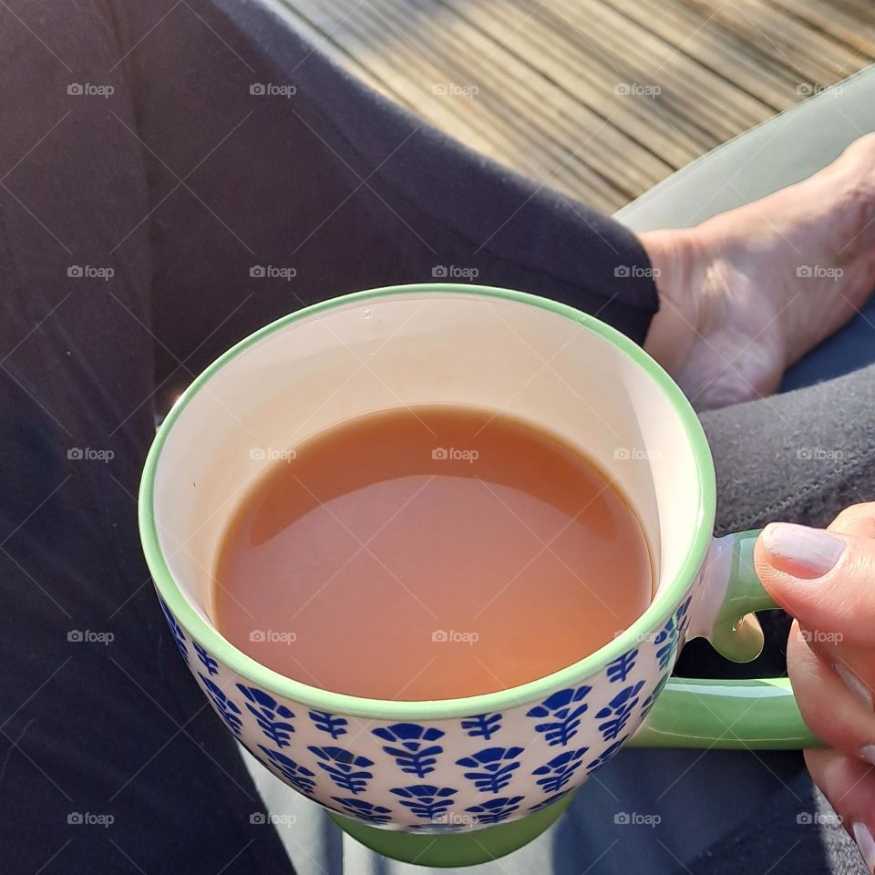 cup of tea. cuppa. teabreak. relax. hand holding cup or mug