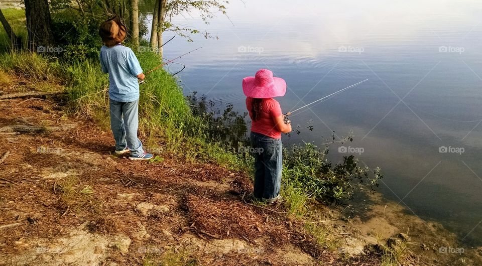 A Boy and a Girl Fishing at the Lake
