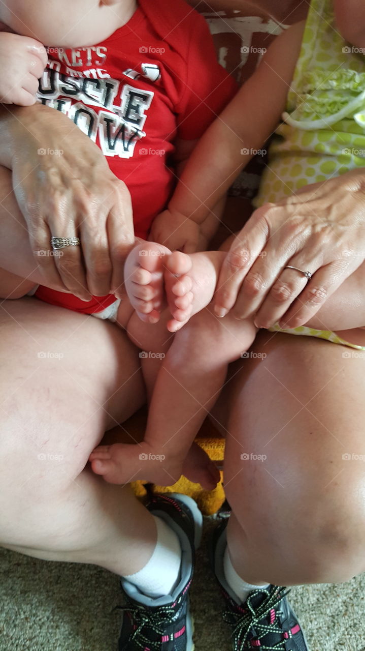 Babies feets grandma's hands