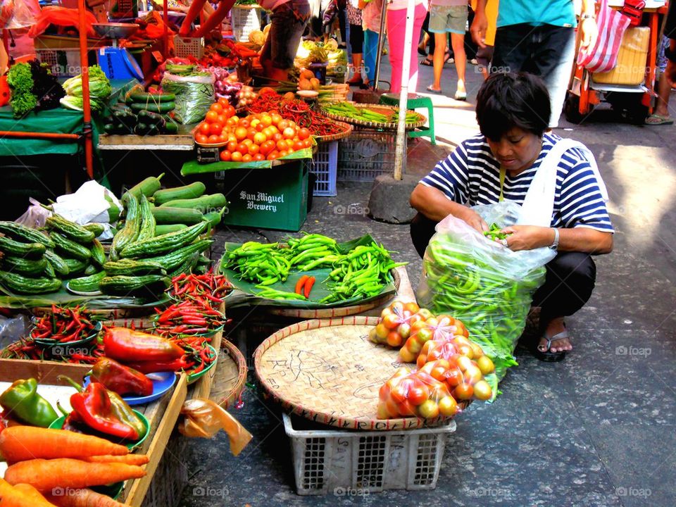 asian street vendor selling fruits and vegetables in quiapo, manila, philippines in asia