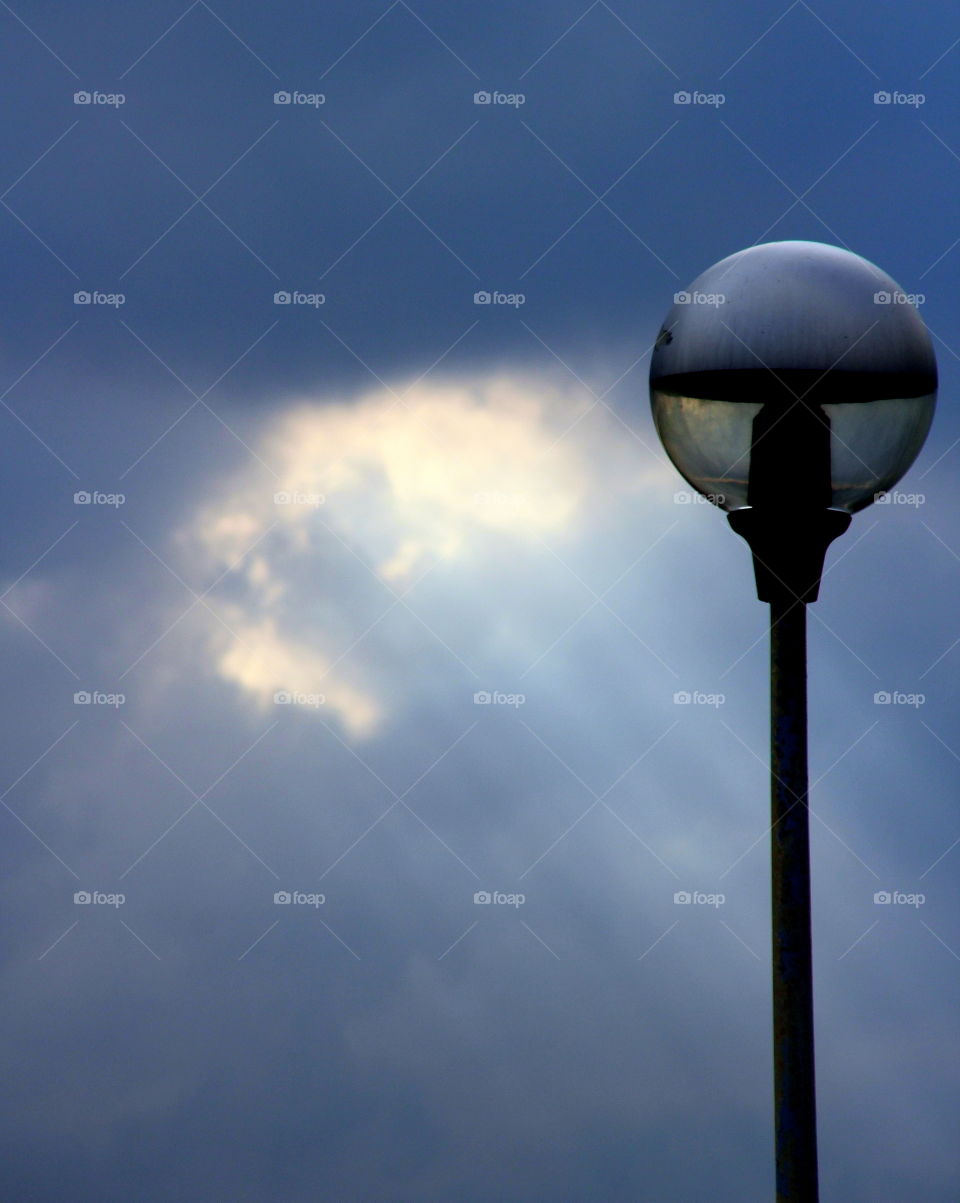 sunrays and a street lamp