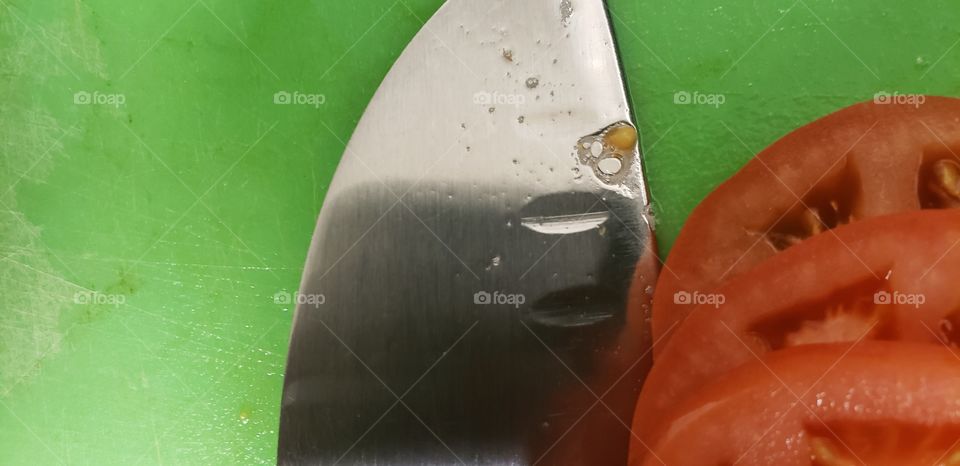 A thin film of tomato blood on my Santoku chef's knife.