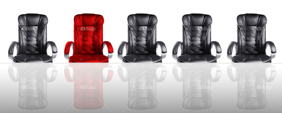 Executive Office chairs -  one red between all black. Unique / being different / stand out concept.
