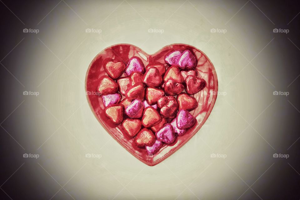 A heart shaped plate full of Valentine's Day chocolates