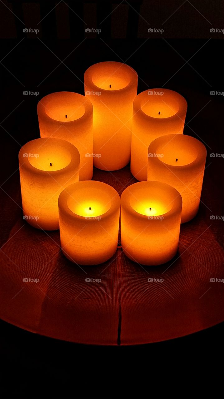 Circle of glowing candles in the dark