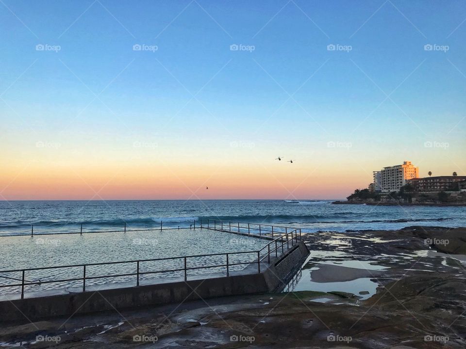 Calm sunset by the ocean pool