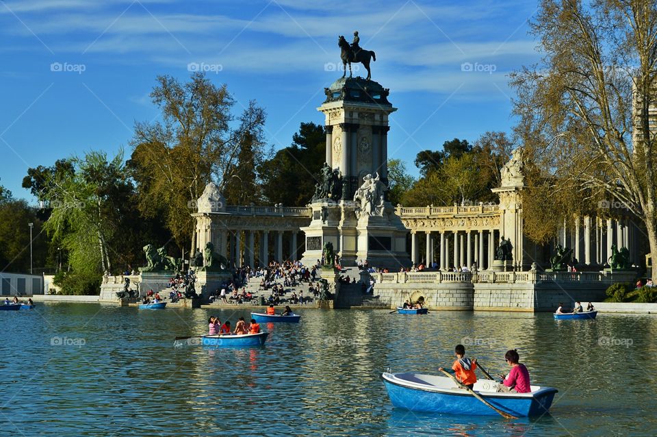 Enjoying spring at the lake in. Enjoying spring at the lake in Buen Retiro Park, with Monument to king Alfonso XII in the background