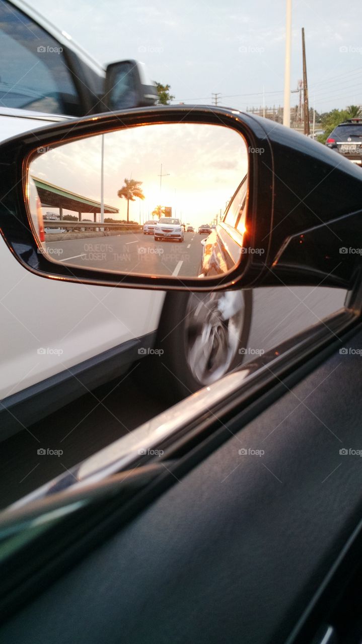 Watching the sunset from the rearview mirror