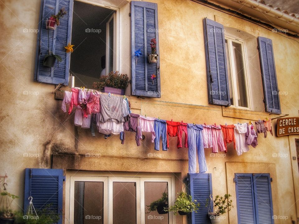 Clothes hanging below window for drying