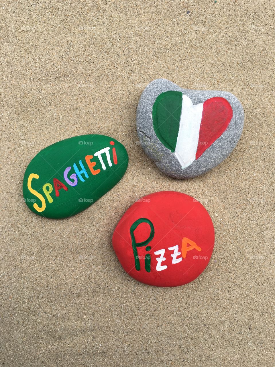 Pizza and spaghetti, italian food names on stones 