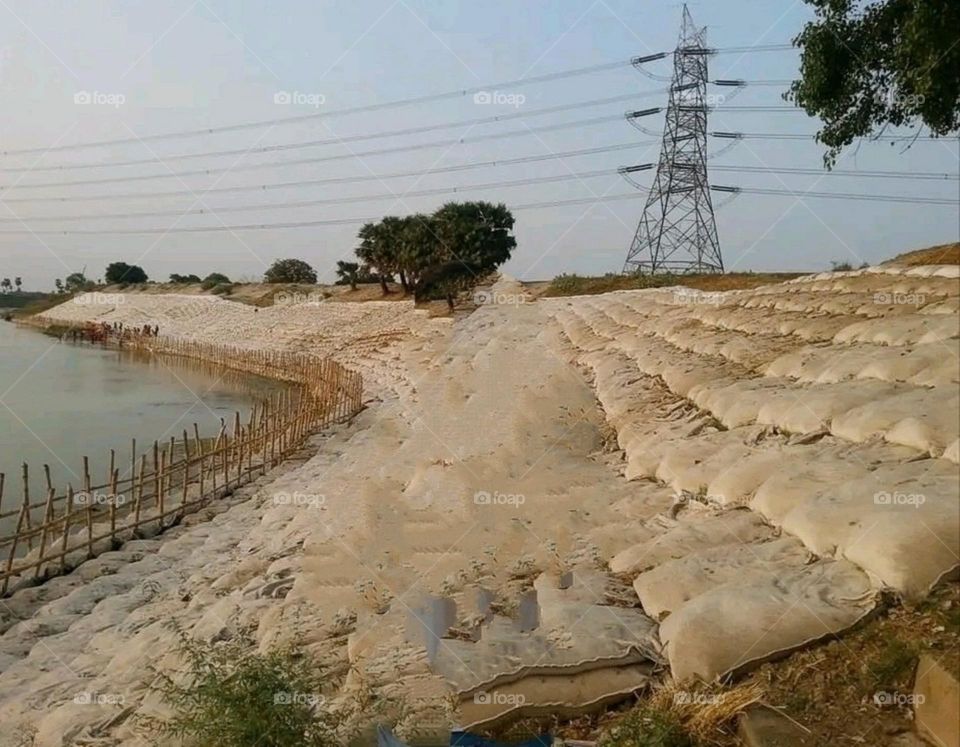 Rain water is being collected by making a dam.