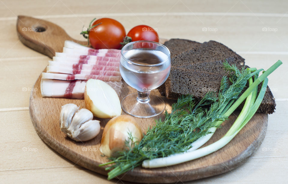 still life of vegetables fats vodkt bread