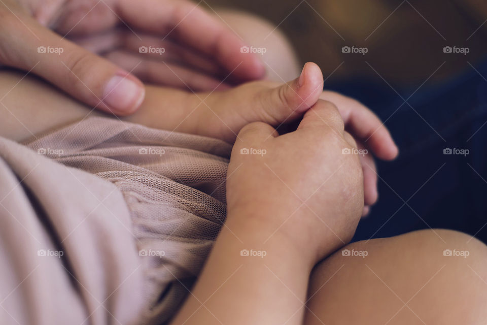 Close-up of hand with child's hand