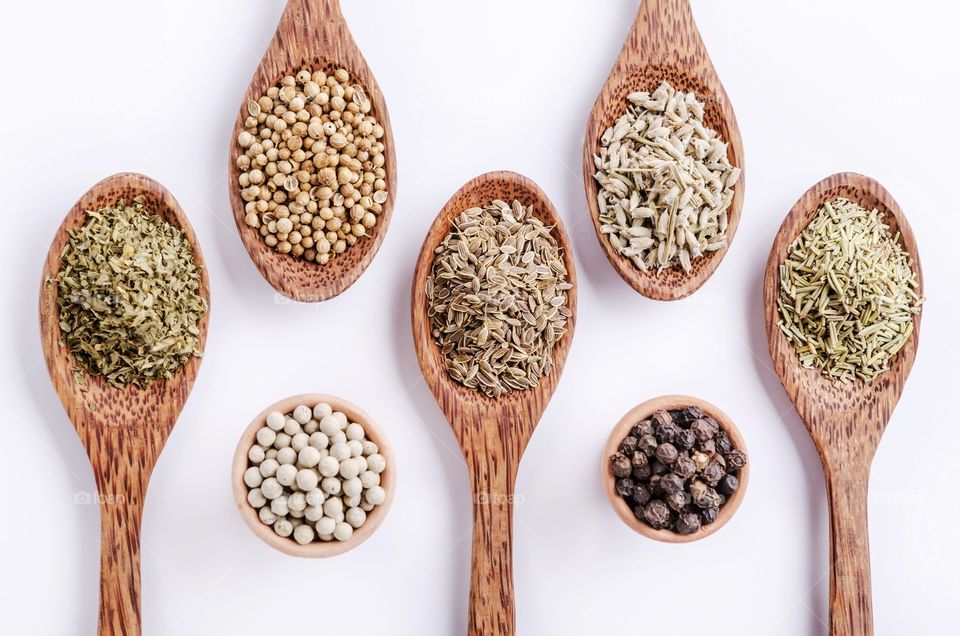 Different type of spices in spoons and tiny cups 