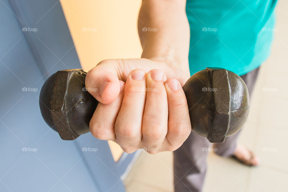 Young woman holding dumbbell