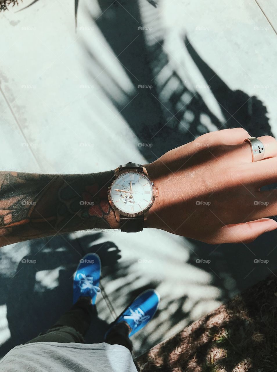 Looking at a watch with some shadows on the ground.  