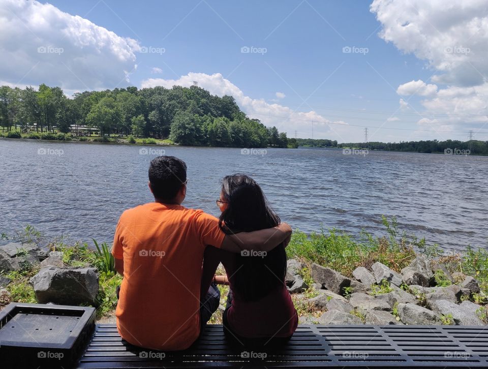 Lovely couple on the bench at the river