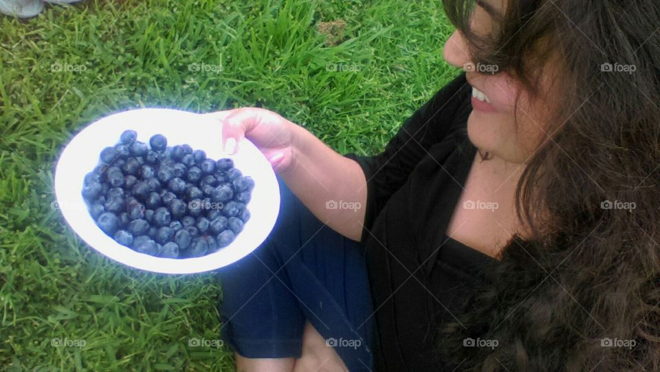 Woman enjoying a healthy snack -blueberries