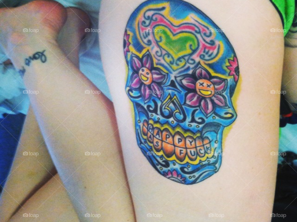 thigh tattoo of sugar skull teeth say "happy as fu**" this is my tattoo and definately one of my favorites amoung my own and others as well