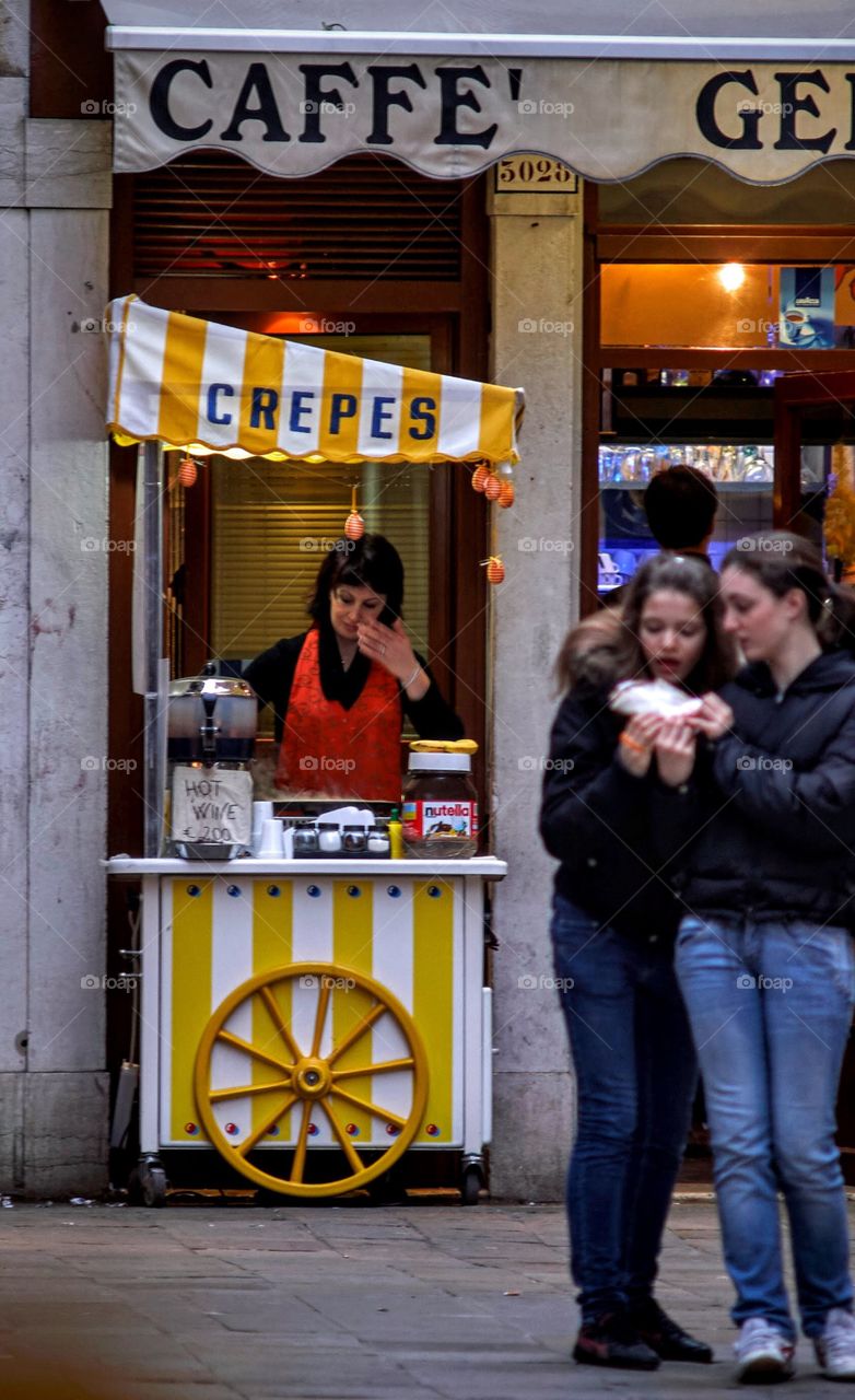 Tourists enjoying crepes in Venice Italy