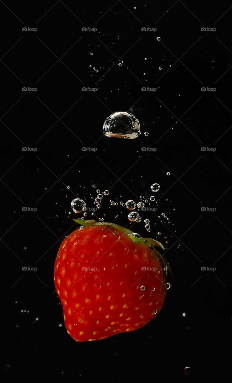 Strawberry droped in water
