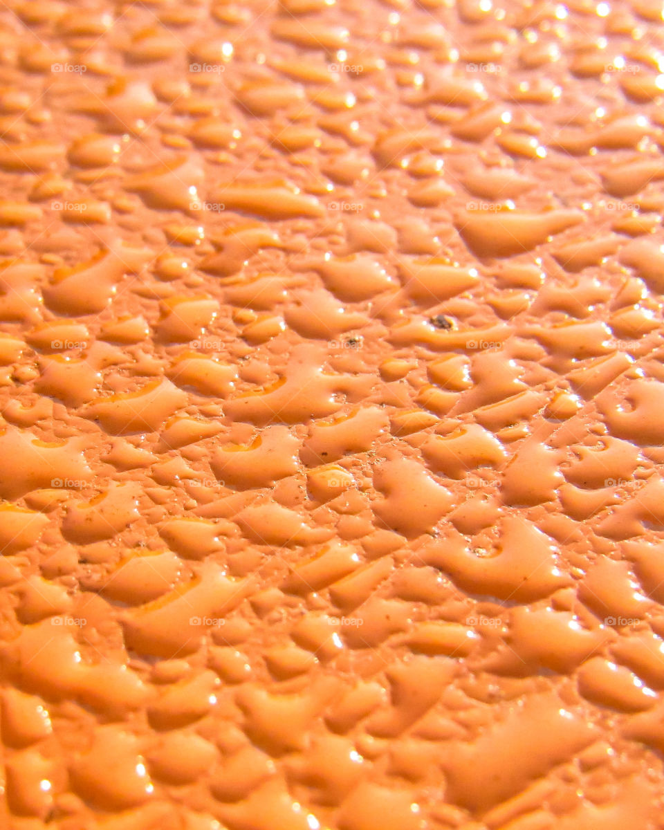 dew drops on orange color metal surface
