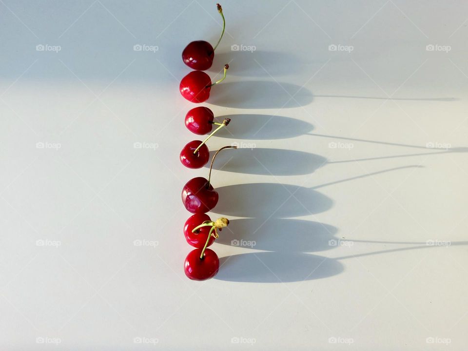cherries and its shadow falling on the table
